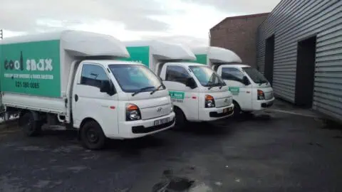 delivery vehicles parked outside a building